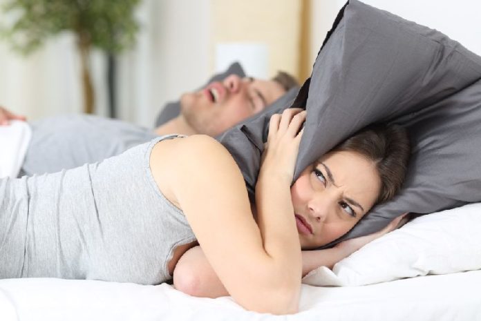 Man,Snoring,While,His,Wife,Is,Covering,Ears,With,The